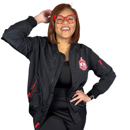Woman wearing a black jacket with red accents